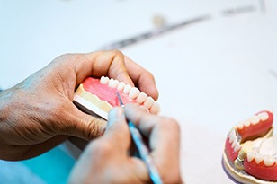 Lab technician creating a set of dentures 