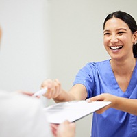 Dental receptionist smiling at patient