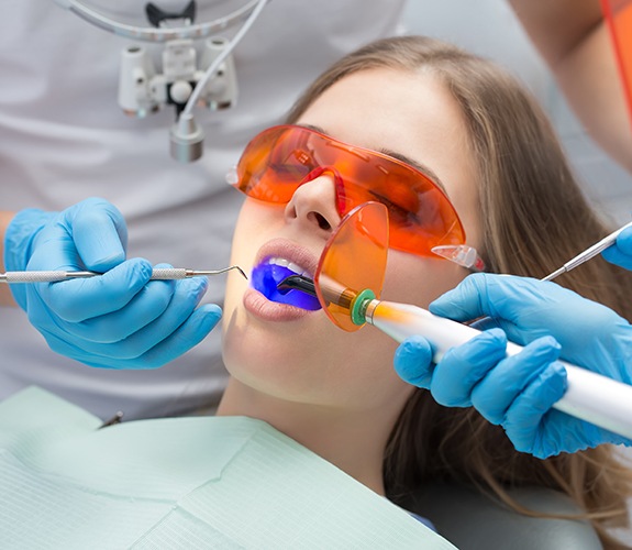 Dental patient receiving tooth-colored filling