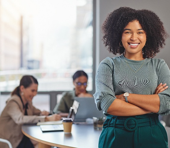 Young woman smiling confidently at work