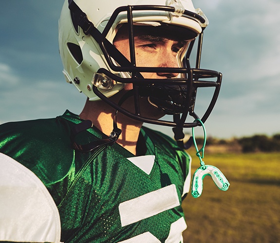 Teen boy with green athletic mouthguard