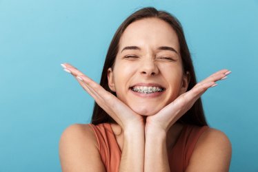 Young woman smiling with dental braces